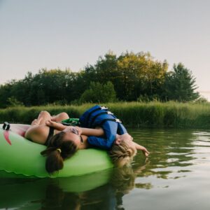 Woman and child floating on a river in a tube
