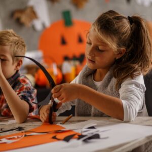 girl making halloween decorations